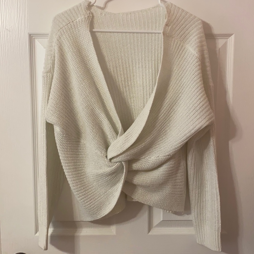 White sweater with low cut.